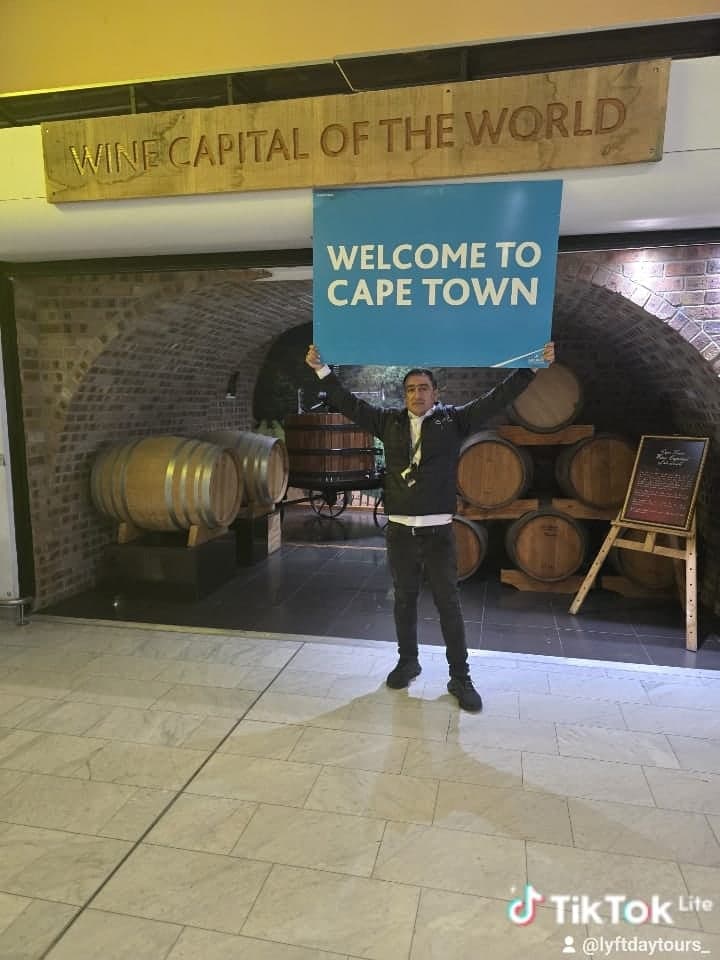 Your driver holding a Welcome to Cape Town sign at arrivals