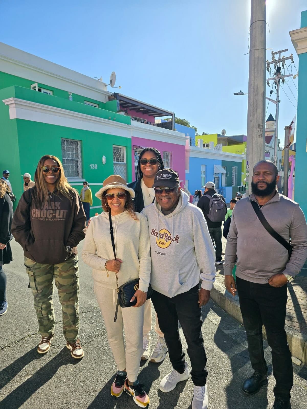 Group of five guests in front of the colourful Bo-Kaap houses