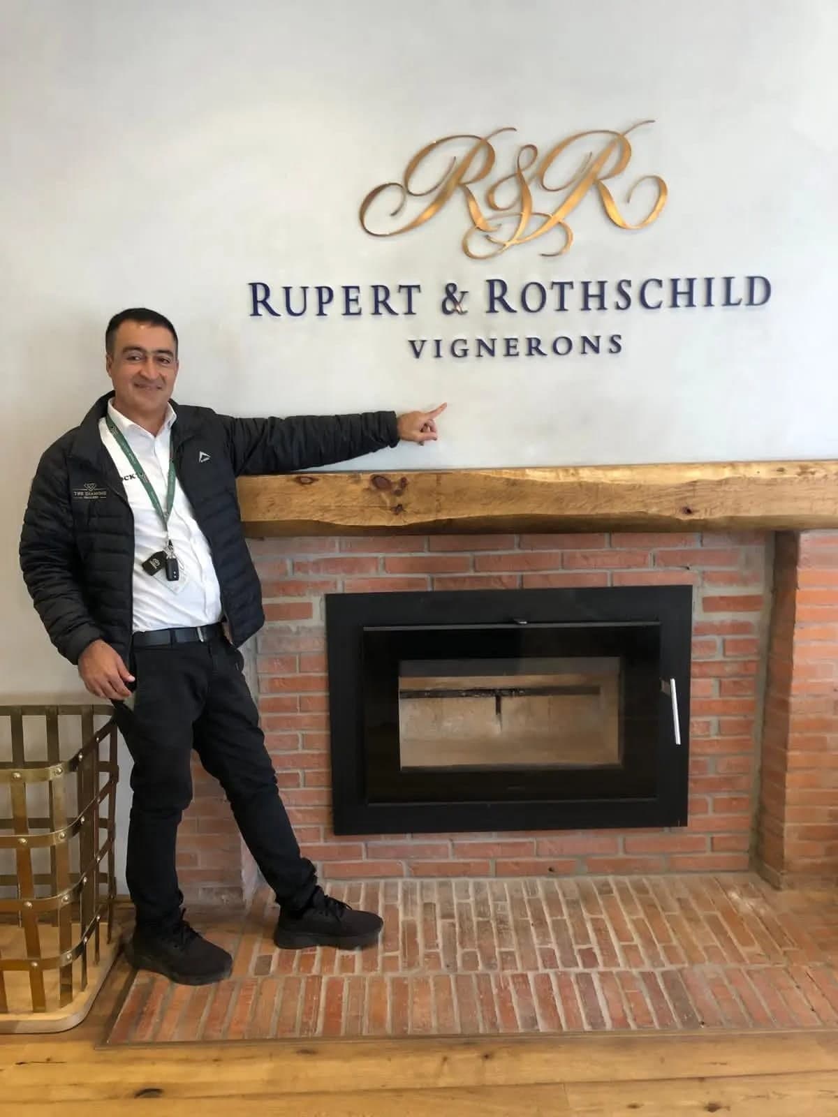 Your guide pointing at the Rupert & Rothschild sign at the wine estate