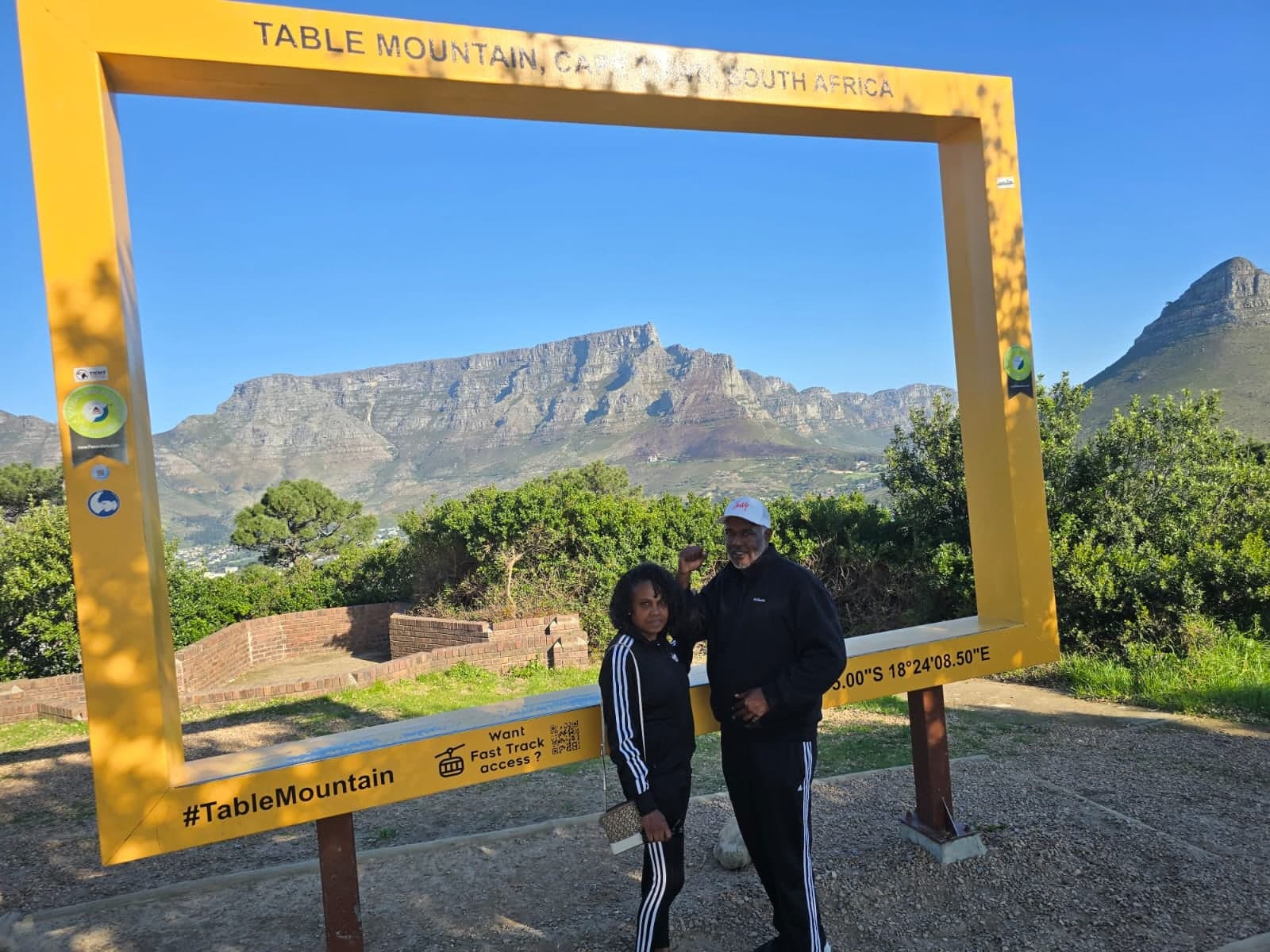 Couple posing in the yellow Table Mountain photo frame
