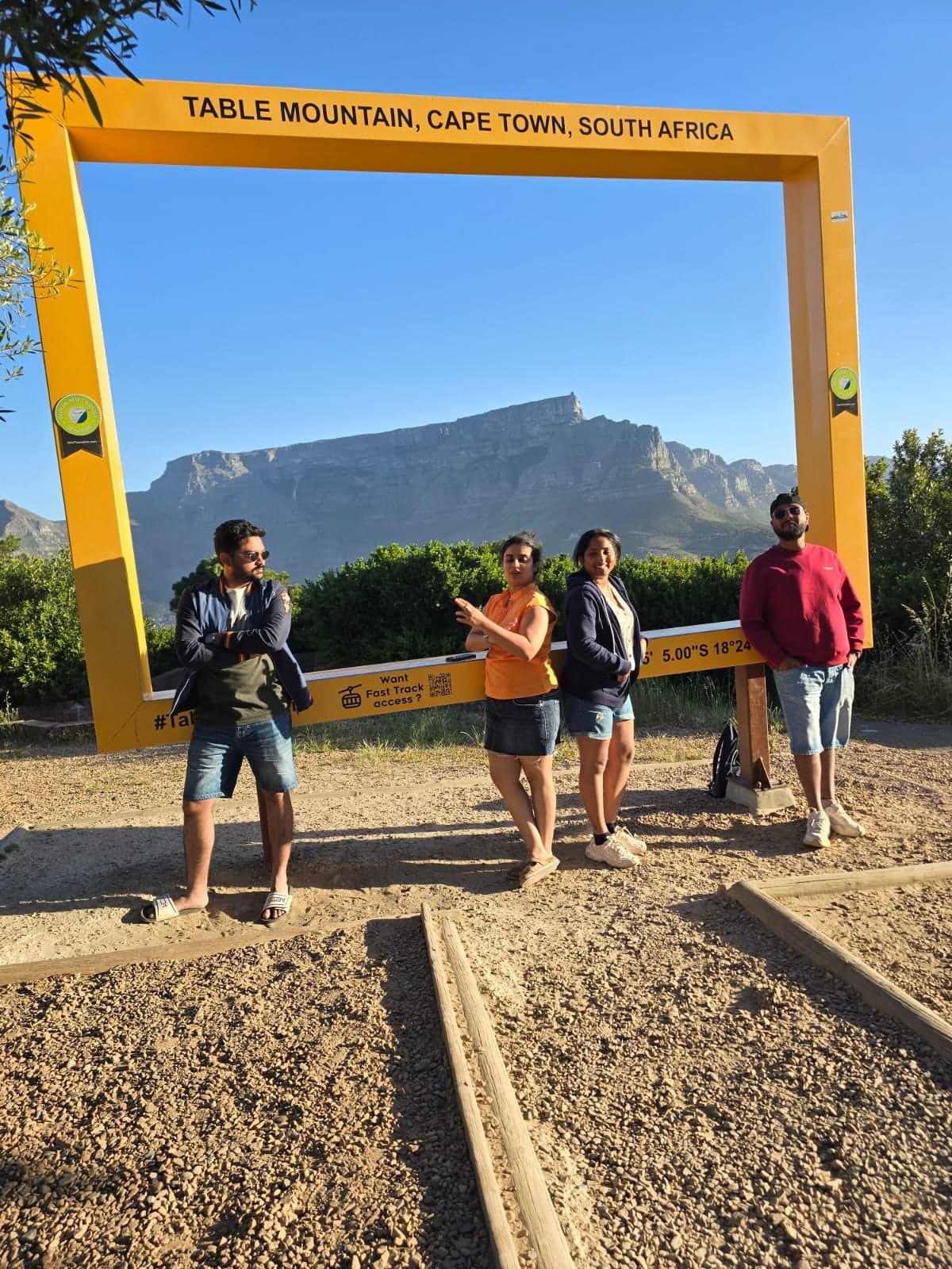 Four friends at the yellow Table Mountain frame in the evening sun